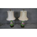A pair of hand decorated ceramic baluster shaped table lamps with gilt metal filigree finials