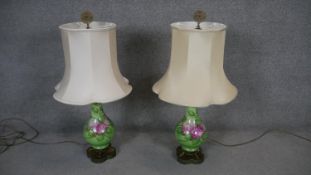 A pair of hand decorated ceramic baluster shaped table lamps with gilt metal filigree finials