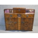 A mid century Art Deco style burr walnut drinks cabinet with central sliding fitted cocktail section