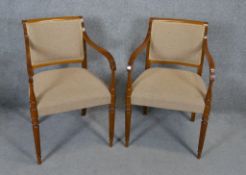 A pair of contemporary late Georgian style armchairs on reeded tapering supports.