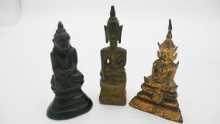 A collection of three antique Chinese gilt bronze Buddhas in lotus position. H.15cm (Tallest)