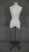 A vintage mannequin on metal adjustable four spoke stand on casters. H.148cm