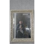 A bevelled plate wall mirror in foliate silvered frame. H.89 W.66