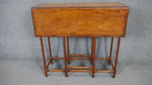 A 19th century satinwood and rosewood crossbanded drop flap table with spider gateleg action. H.70