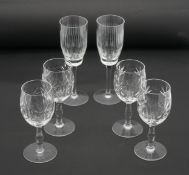 Six cut crystal glasses. Including a set of four stylised foliate design sherry glasses and a pair