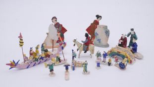 A collection of Chinese hand painted ceramic miniature figures along with a painted festival scene