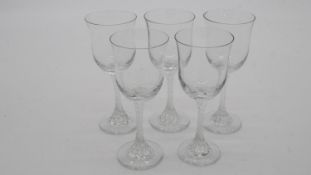 A set of five Victorian twist stem clear sherry glasses with flared rims.