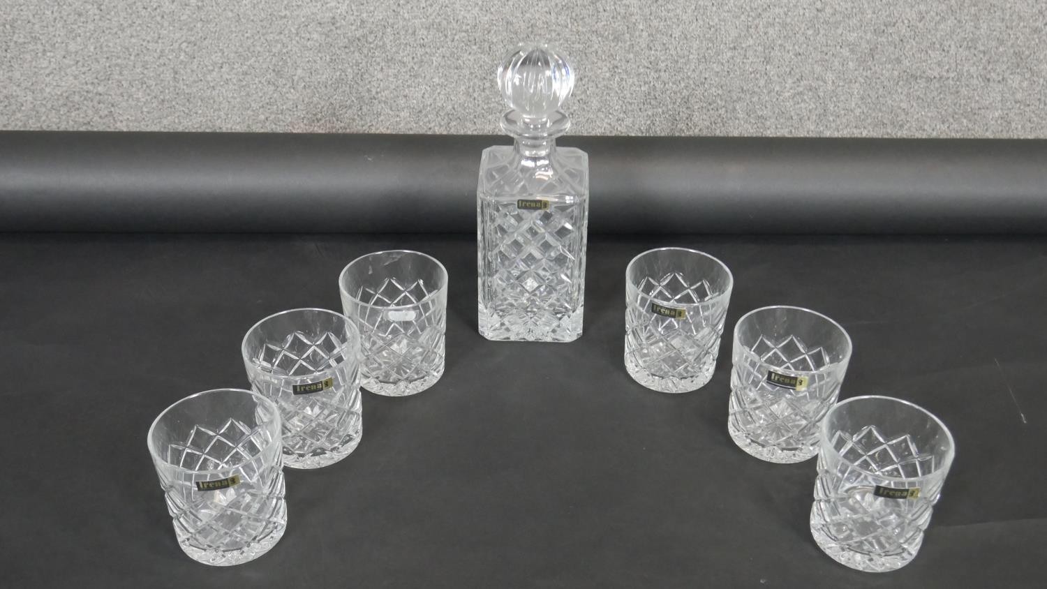 An Irena cut crystal decanter and six whisky tumblers. Makers labels on all. H.16cm