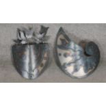 Two tempered steel pierced wall sconces. One in the form of a Nautilus shell and one as a vase of