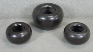 Three bronze effect Indian doughnut shaped bowls. H.29 D.40