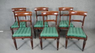 A set of six William IV mahogany dining chairs with acanthus carved backs and drop in seats on