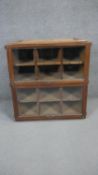 A vintage oak filing cabinet section with twin glazed lift up doors enclosing sliding pigeon hole