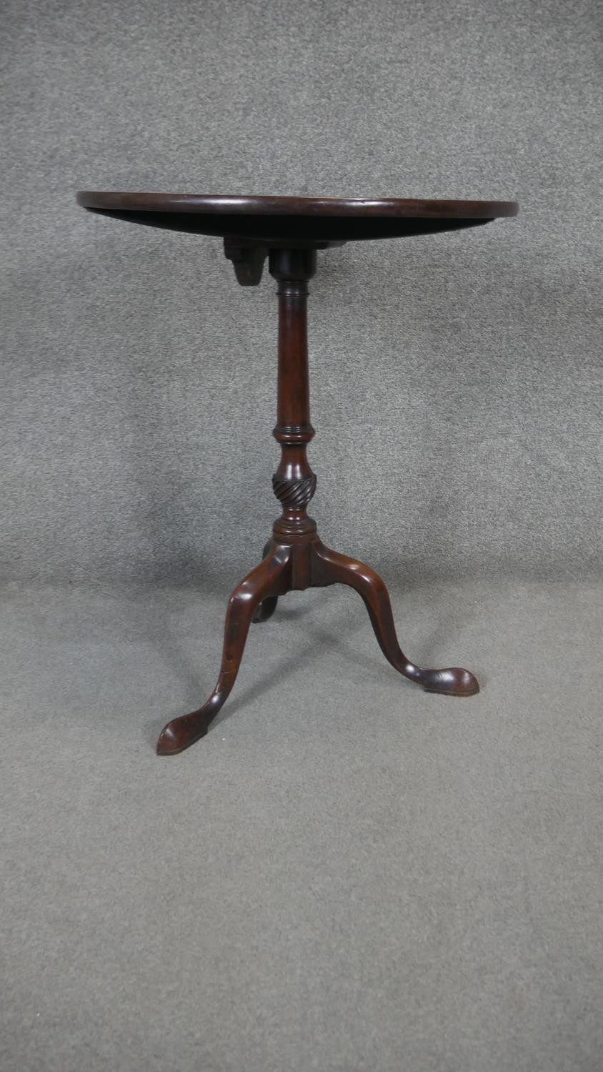 A Georgian mahogany tilt top occasional table on carved tripod cabriole base. H.71 Dia.57cm