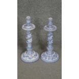 A pair of Casa Pupo Portuguese blue and white hand painted ceramic candle sticks with foliate and