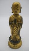 A 20th century gilt bronze Buddha figure standing on a lotus leaf, impressed mark to base. H.26cm