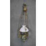An Art Nouveau gilt metal and ceramic adjustable height oil lamp with weighted fitting. The