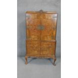 A mid century burr walnut Epstein drinks cabinet with mirrored back and sycamore lined, fitted and