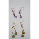 Two pairs of antique earrings. One pair of 9 carat rose gold and amethyst drop earrings and a pair