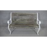 A vintage painted wrought iron garden bench with weathered teak slatted seat. dH.84 W.125 D.62cm