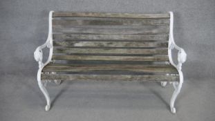 A vintage painted wrought iron garden bench with weathered teak slatted seat. dH.84 W.125 D.62cm