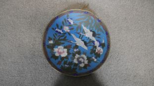 A 1900's Japanese cloisonne enamel and bronze charger with crane and flower decoration on a pale