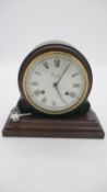 A mahogany vintage mantle clock by Comitti of London, white enamel dial with black Roman numerals.