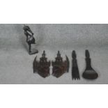 A collection of five carved items. Including a pair of Thai heads, a pair of salad servers and a