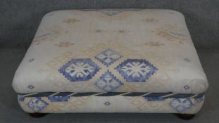 An upholstered stool in kelim style upholstery on bun feet. H40 W103 D86CM