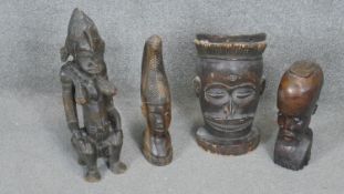 Four carved hardwood tribal figures. Three African busts and one fertility statue. H.47CM