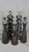 Five carved and stained table lamps. A pair with undulating bulbous design and three with