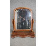 A Victorian mahogany toilet mirror on shaped base. H.69 W.54cm