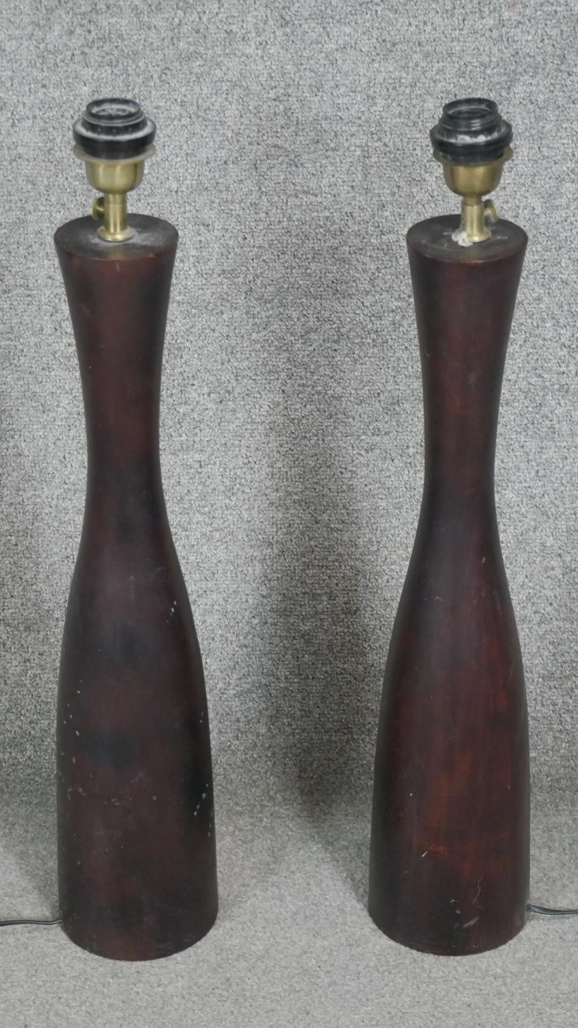 A pair of carved stained table lamps of cylindrical design. H.70CM