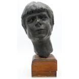 A hollow bronze female sculpted head on wooden stand. H.45cm