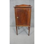 An Edwardian mahogany and satinwood inlaid pot cupboard on tapering square supports terminating in