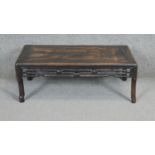 A Chinese Kang carved hardwood low table with carved pierced frieze on shaped supports. H.27 W.72