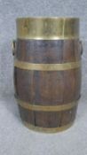 A Victorian brass banded coopered oak barrel with twin handles. H.33 D19CM
