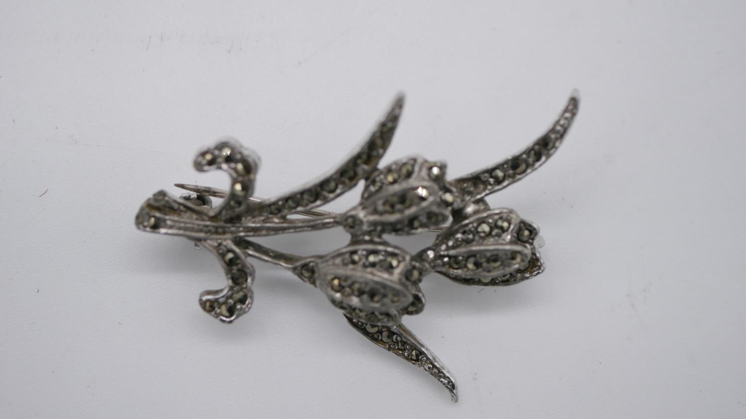 An engraved hollow marked 9ct gold bar brooch and two marcasite flower brooches. - Image 3 of 5