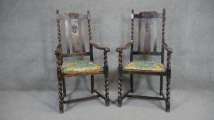A pair of mid century oak armchairs on stretchered barleytwist supports.