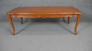 A French Provincial style fruitwood coffee table on carved cabriole supports. H.45 W.130 D.62