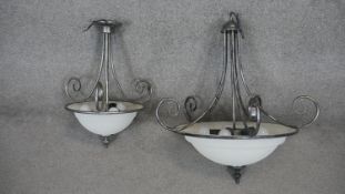 A metal framed ceiling light with domed frosted shade and a similar smaller example. H.70 W.70cm (