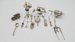 A collection of silver and white metal items. Including two Indian white metal peacock figures, a