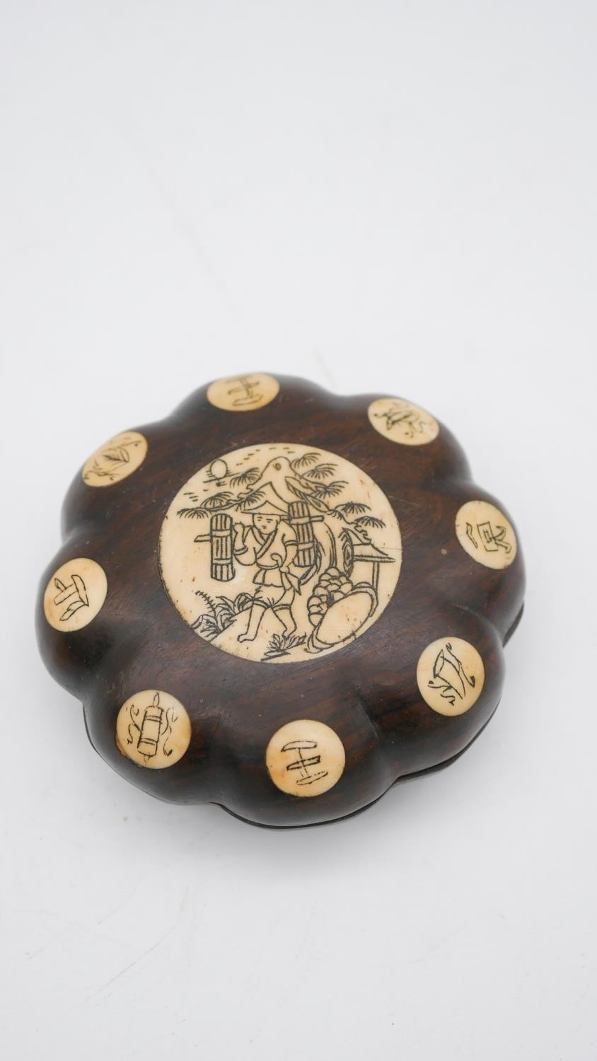 A 20th century Chinese Feng Shui rosewood and bone compass. In a rosewood case with eight bone