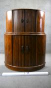 A mid century Art Deco style burr walnut cocktail cabinet with tambour doors to the upper and