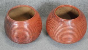 Two large terracotta effect ceramic ridged globe shaped vases. H.28 D.34
