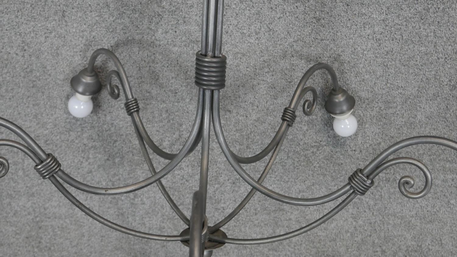 A wrought metal five branch chandelier with scrolling arms. Dia.90cm - Image 4 of 4