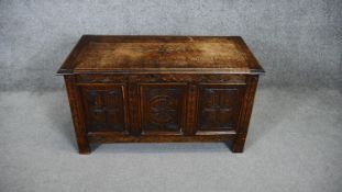 A mid century carved oak coffer on block supports. H.50 W.90 D.45