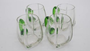Four Bohemian clear blown glass tankards with green pulled glass handles.