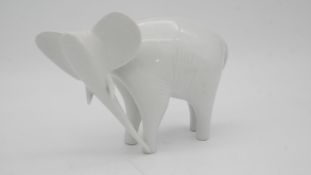 A mid century Royal Dux Czech white porcelain Elephant. Makers stamp to the base.