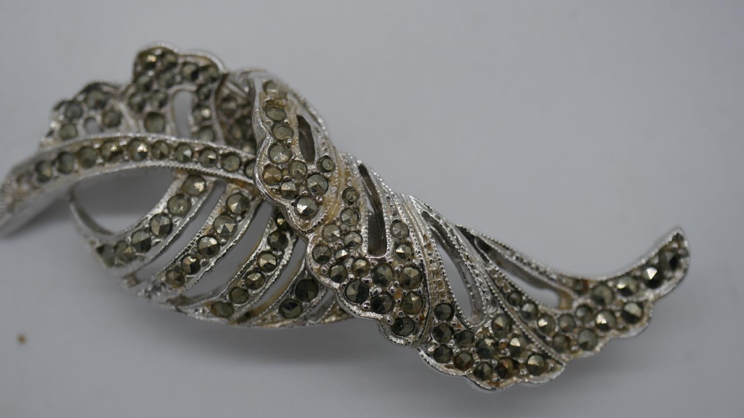 An engraved hollow marked 9ct gold bar brooch and two marcasite flower brooches. - Image 4 of 5
