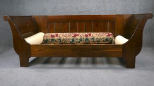 A Biedermeier style day bed with scroll arms on shaped supports. H. 74 W. 195 D. 84